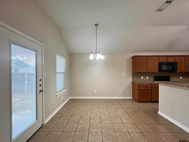 a kitchen with granite countertop a sink a stove and a wooden floor