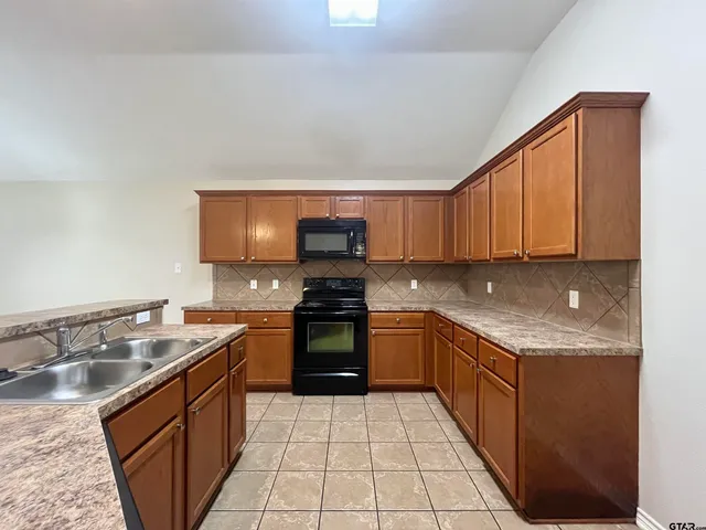 a kitchen with a sink and stove