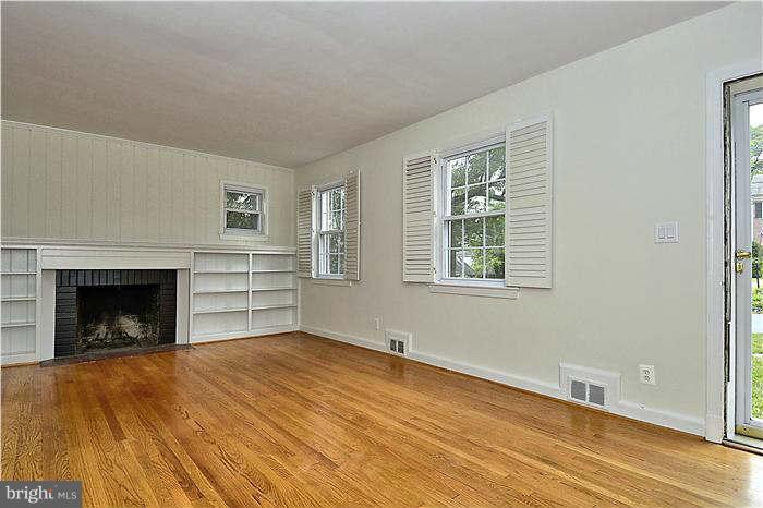 505 Lanark Way Silver Spring, MD 20901 - Photo 5 of 30 a view of empty room with wooden floor and fireplace