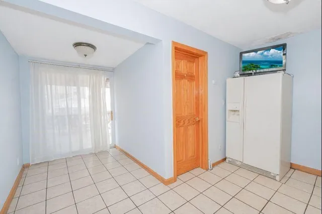 an empty room with windows and stairs