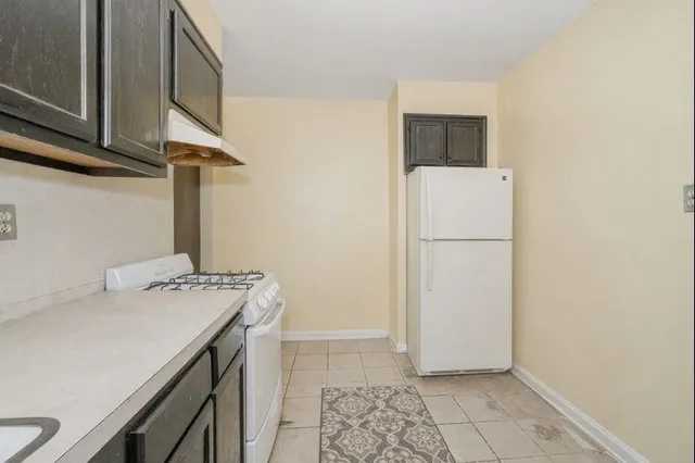 a view of a room with wooden floor and fan