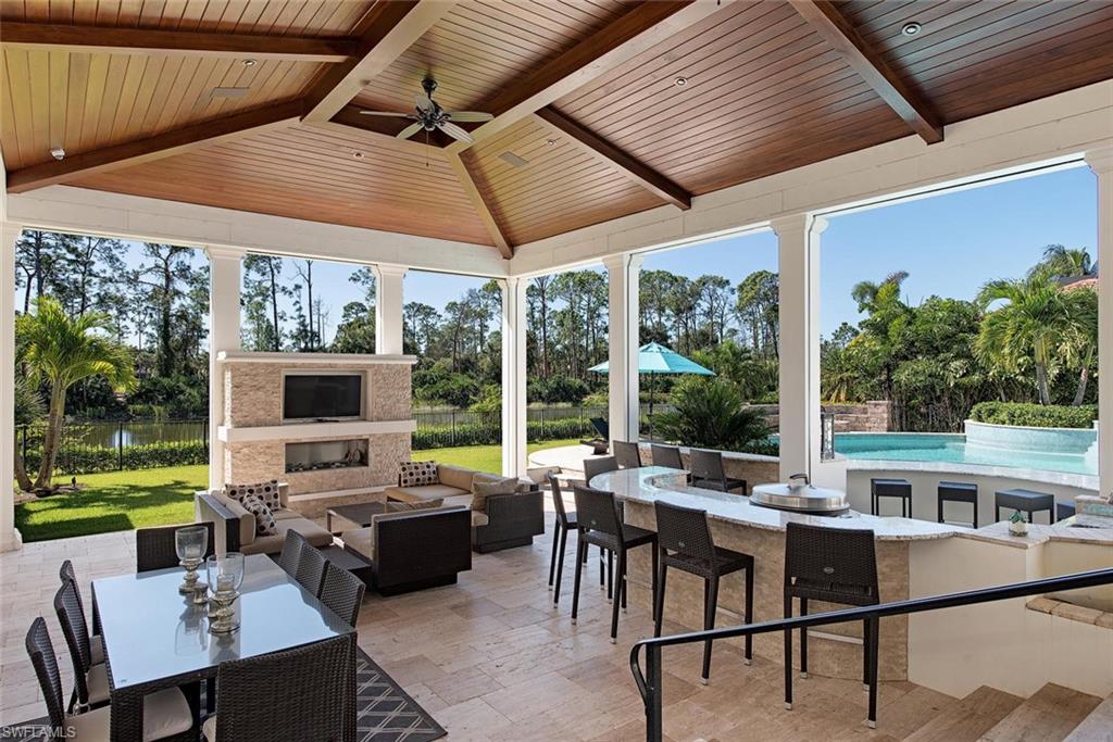 a view of a patio with a table chairs and a backyard