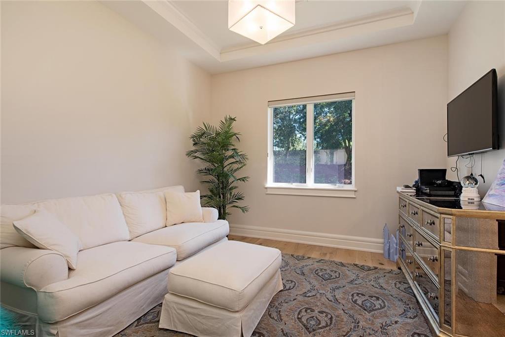 16044 Trebbio Way Naples, FL 34110 - Photo 14 of 33 a living room with furniture and a flat screen tv