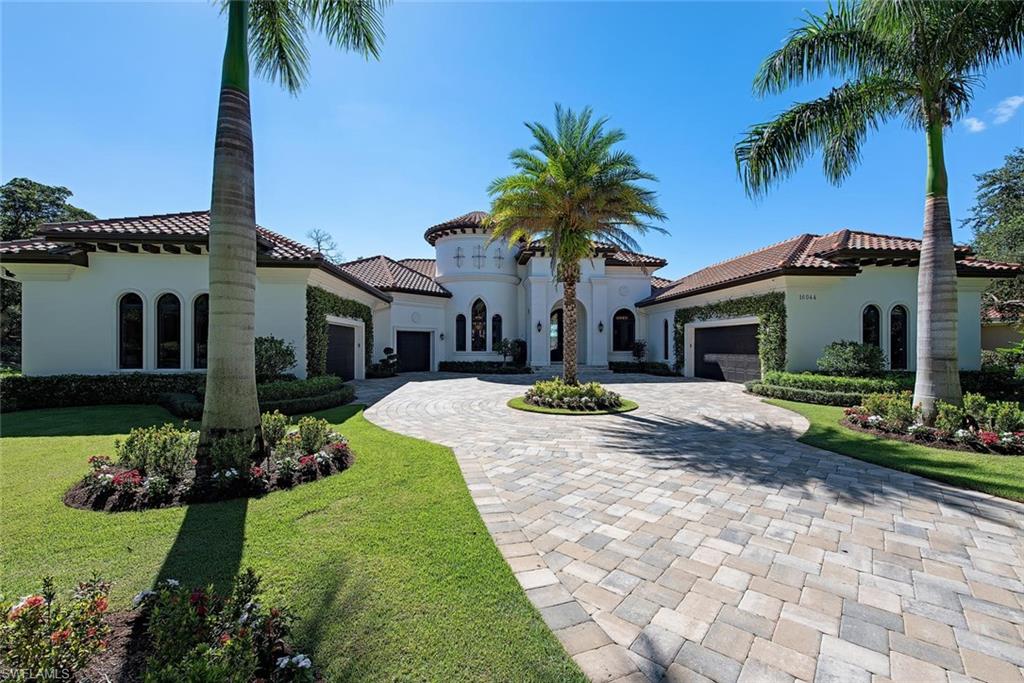 16044 Trebbio Way Naples, FL 34110 - Photo 20 of 33 a front view of a house with a garden and patio