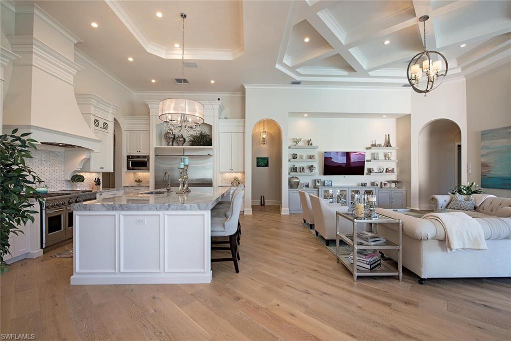16044 Trebbio Way Naples, FL 34110 - Photo 2 of 33 a living room with lots of furniture and kitchen view