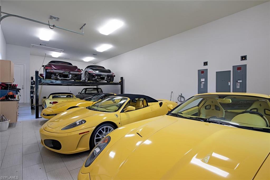 16044 Trebbio Way Naples, FL 34110 - Photo 21 of 33 a bedroom with bed and a chandelier