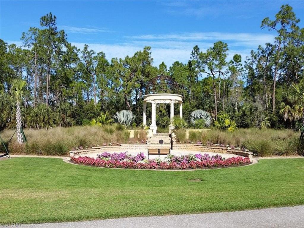 16044 Trebbio Way Naples, FL 34110 - Photo 29 of 33 a front view of a house with a yard and fountain
