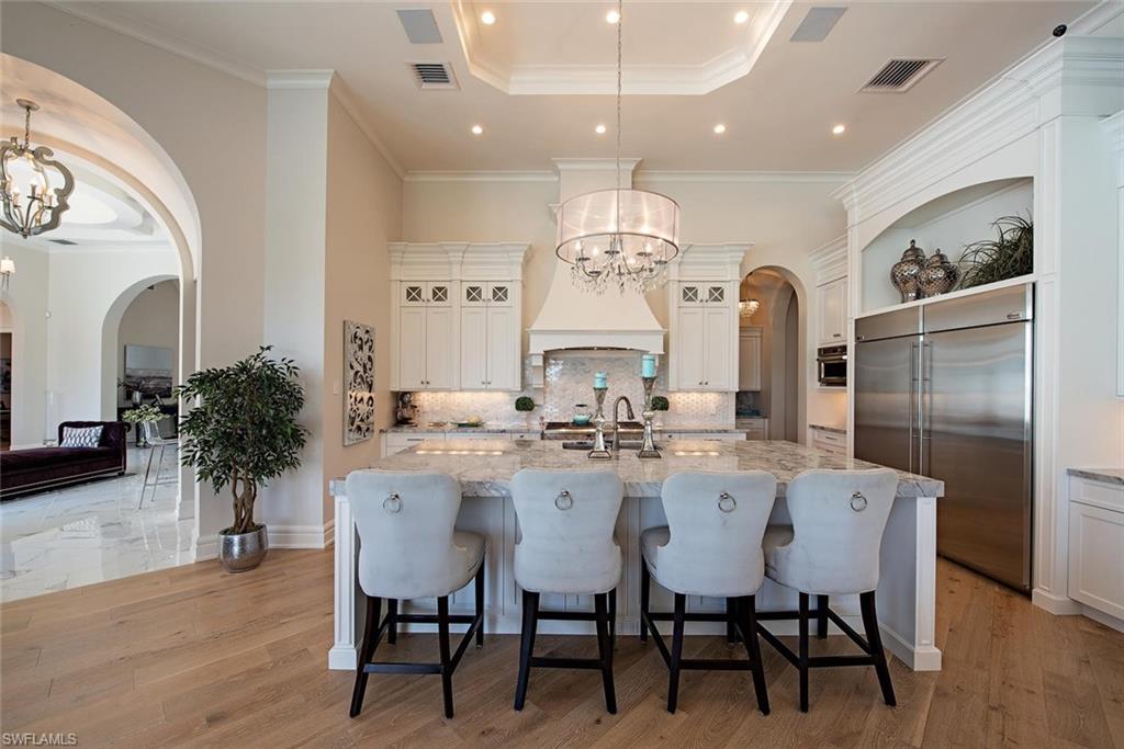 16044 Trebbio Way Naples, FL 34110 - Photo 3 of 33 a view of a dining room with furniture and wooden floor