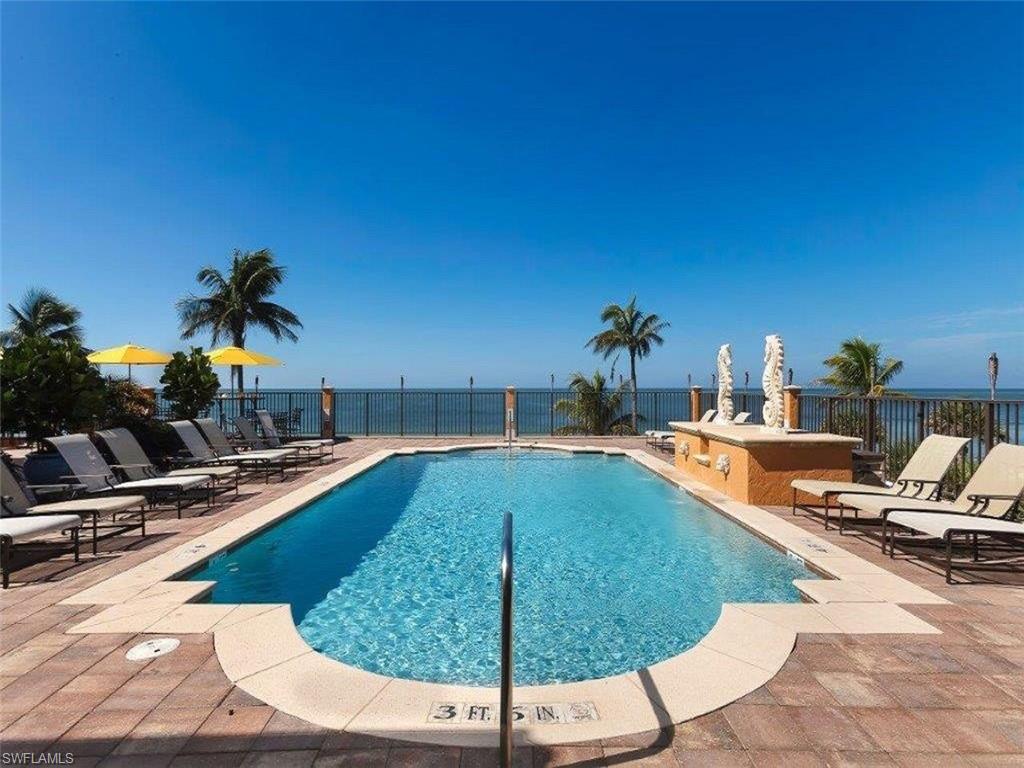 16044 Trebbio Way Naples, FL 34110 - Photo 31 of 33 a view of a swimming pool with lounge chairs