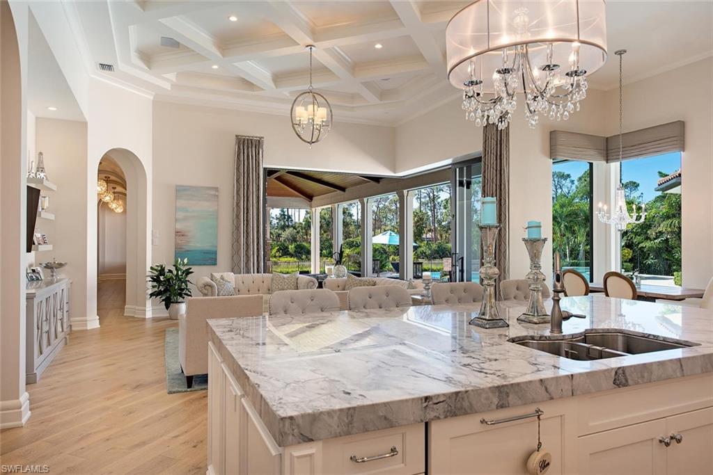 16044 Trebbio Way Naples, FL 34110 - Photo 4 of 33 a view of a kitchen with granite countertop a sink and chandelier