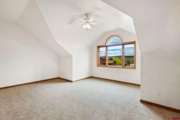 a bathroom with a sink a washer and dryer next to a window