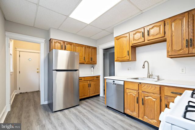 a kitchen with stainless steel appliances granite countertop a refrigerator sink and cabinets