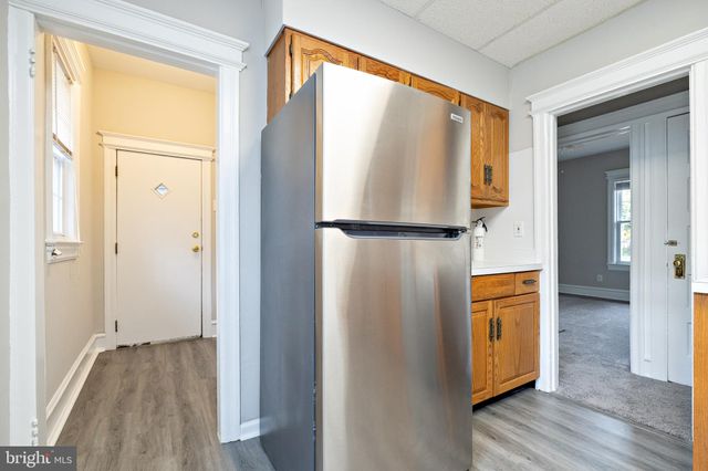a view of walk in closet with wooden floor