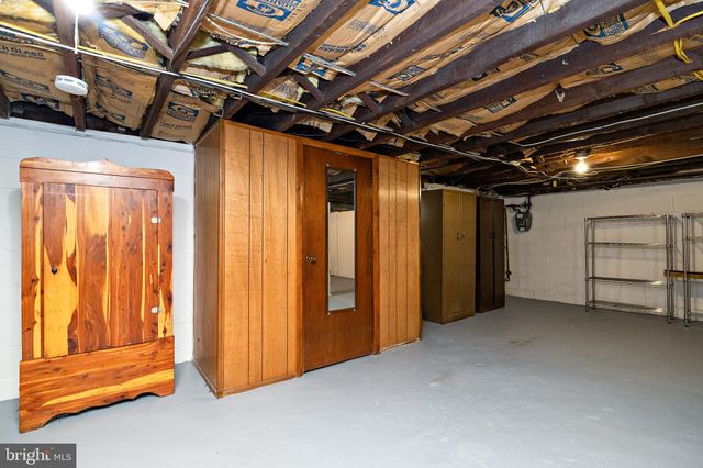 a view of empty room with wooden walls