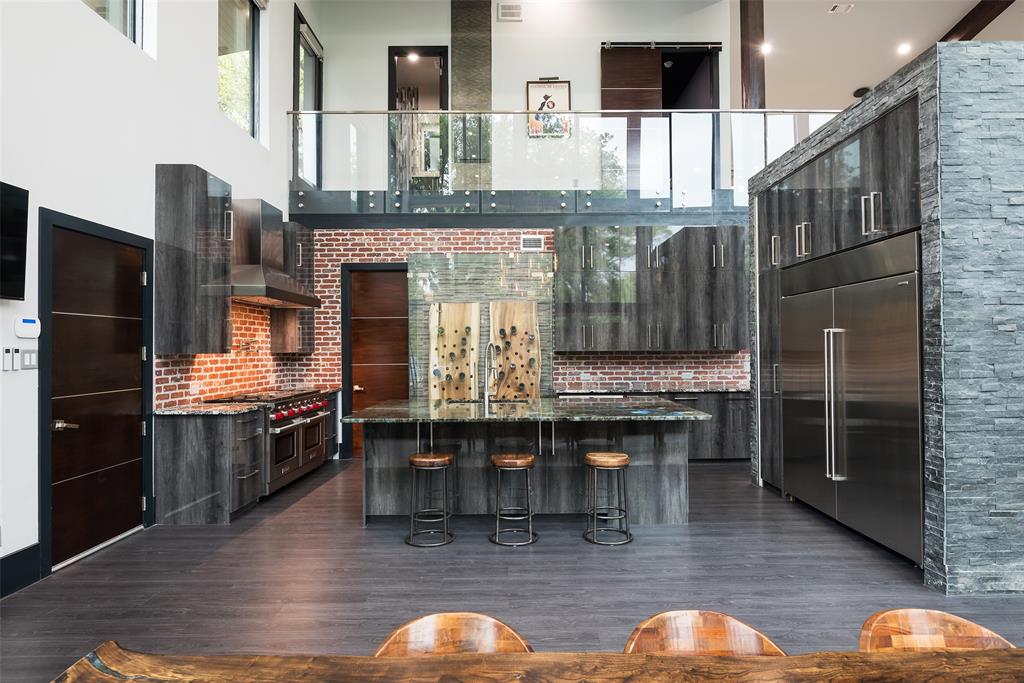 6766 Northaven Road Dallas, TX 75230 - Photo 14 of 40 a kitchen with stainless steel appliances granite countertop a stove and a refrigerator