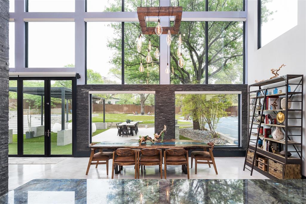 6766 Northaven Road Dallas, TX 75230 - Photo 16 of 40 a living room with large windows and a table