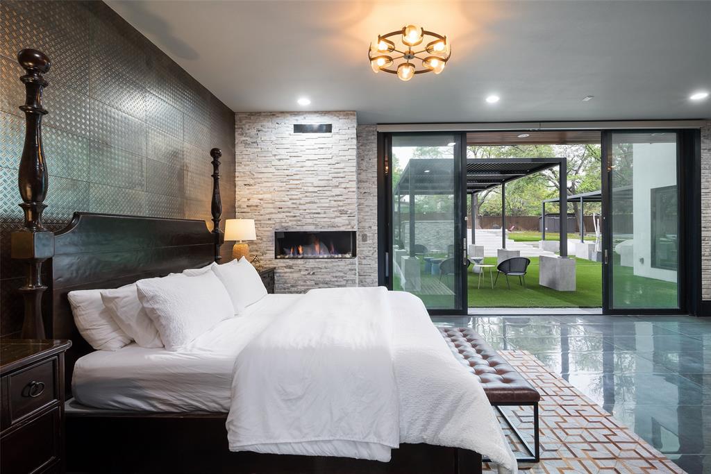 6766 Northaven Road Dallas, TX 75230 - Photo 17 of 40 a living room with furniture a floor to ceiling window and a fireplace