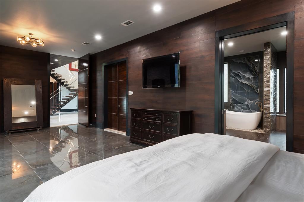 6766 Northaven Road Dallas, TX 75230 - Photo 20 of 40 a bed room with a bed and a television