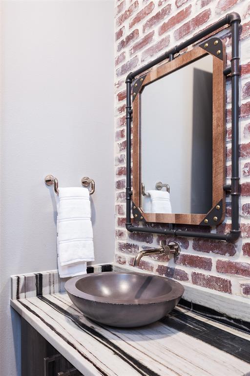 6766 Northaven Road Dallas, TX 75230 - Photo 24 of 40 a bathroom with a sink and a mirror