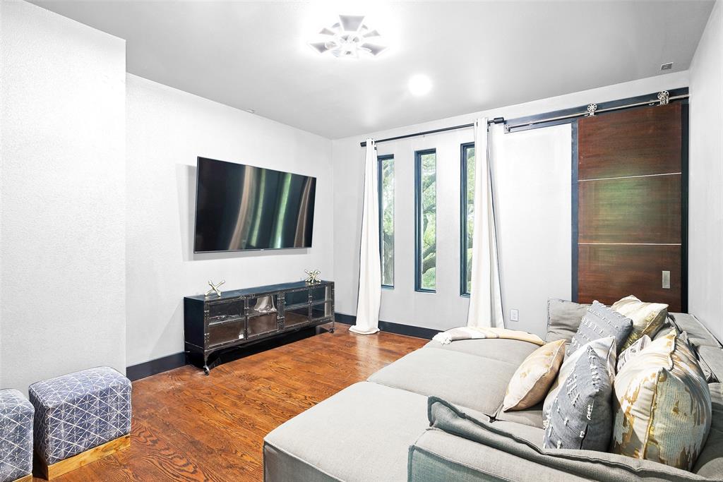 6766 Northaven Road Dallas, TX 75230 - Photo 25 of 40 a living room with furniture and a flat screen tv