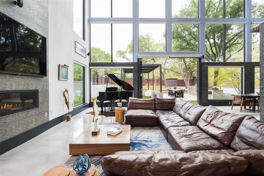 6766 Northaven Road Dallas, TX 75230 - Photo 9 of 40 a living room with furniture a flat screen tv and a large window