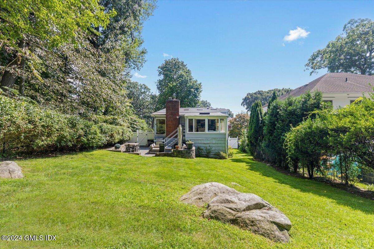 70 Gregory Road Cos Cob, CT 06807 - Photo 31 of 39 a view of a house with backyard porch and garden