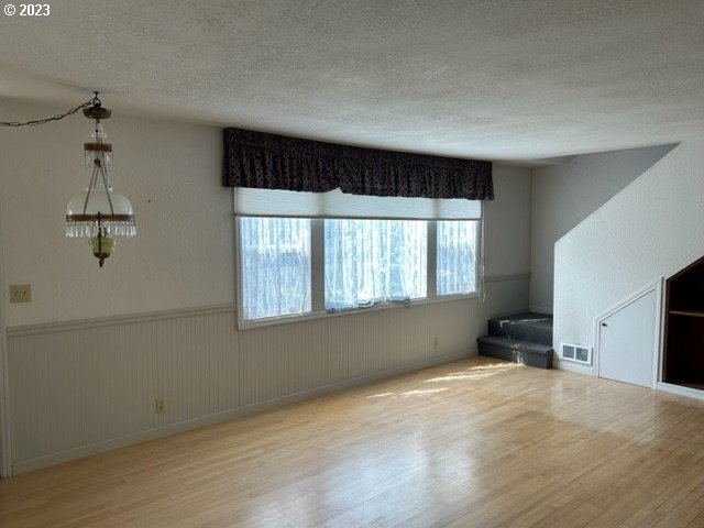 636 Laurel Street Florence, OR 97439 - Photo 11 of 21 wooden floor in an empty room with a window