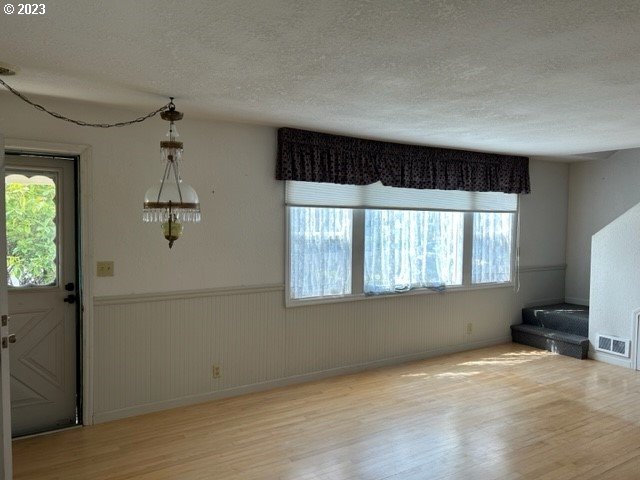 636 Laurel Street Florence, OR 97439 - Photo 10 of 21 wooden floor in an empty room with a window