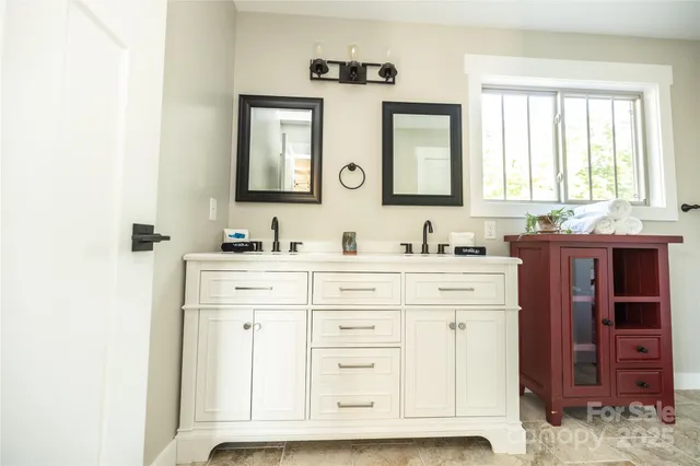 a bathroom with a sink vanity and mirror