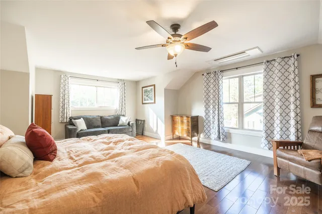 a bedroom with a large bed and a window