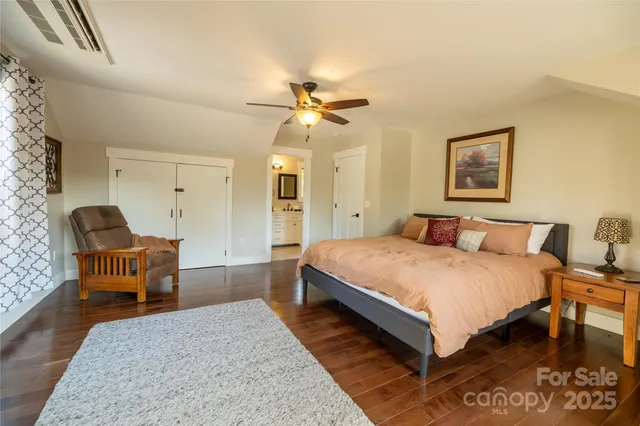 a spacious bedroom with a bed and a chandelier
