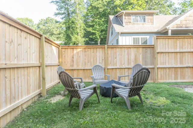 a view of a chairs and table in the backyard