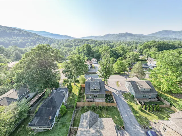 a view of a city with lush green forest