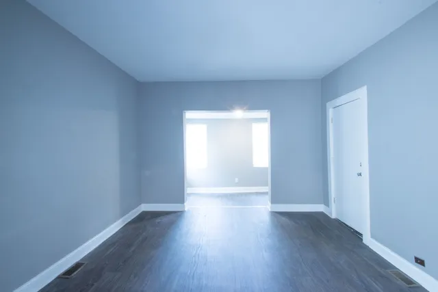 a view of wooden floor and windows in a room