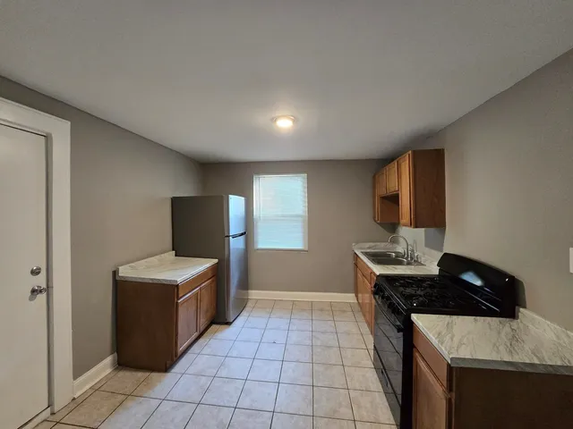 a kitchen that has a sink and a stove in it