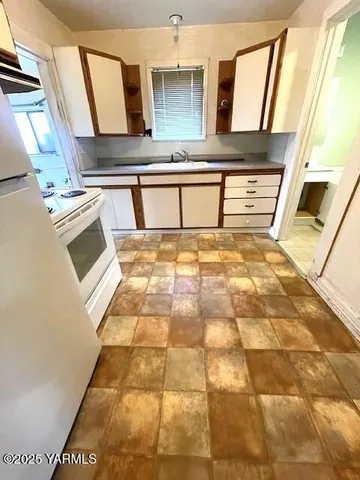 a kitchen with a stove and a refrigerator