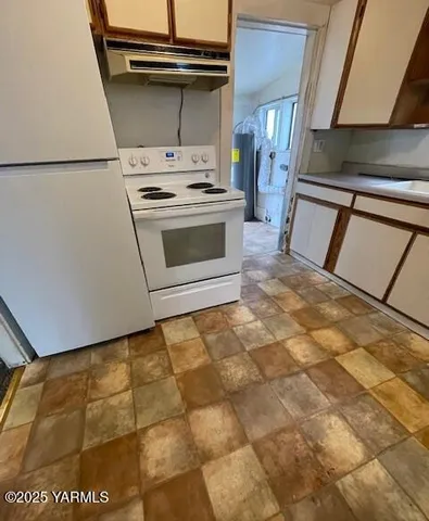 a white toilet sitting next to a bathroom sink