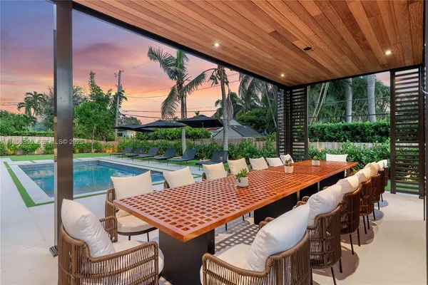 a living room with furniture and a floor to ceiling window