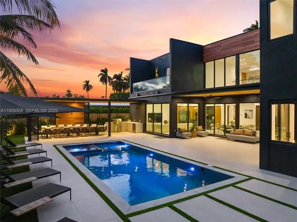 a view of a patio with swimming pool table and chairs