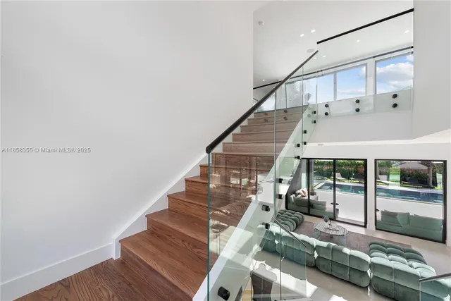 a large kitchen with stainless steel appliances a large counter top a stove and a refrigerator