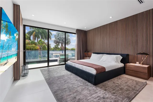 a bedroom with a bed and a large window