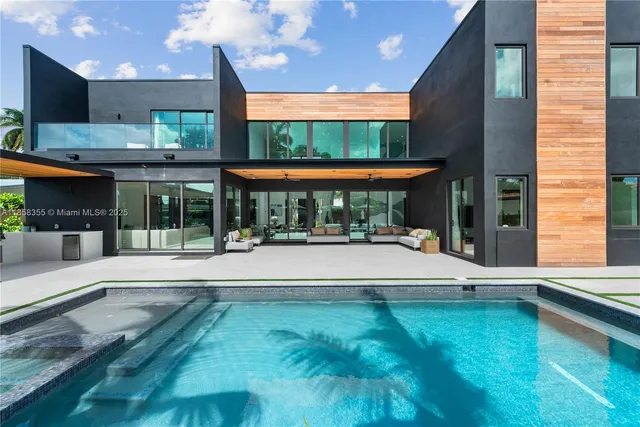 a bathroom with a sink a toilet a glass door shower and a mirror