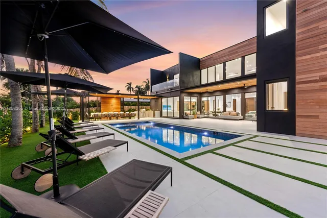 a living room with furniture kitchen view and a large window