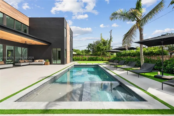 a kitchen with stainless steel appliances a sink and a refrigerator