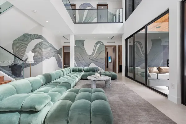 a living room with furniture and a floor to ceiling window