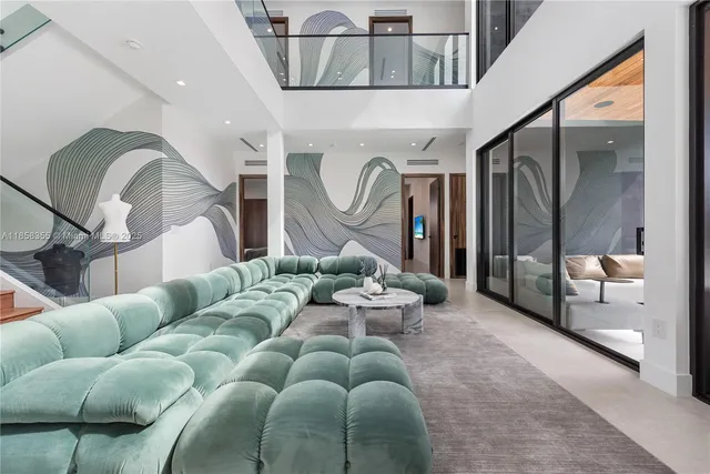 a living room with furniture and a floor to ceiling window