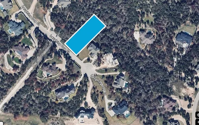 a aerial view of a house with a yard and wooden fence