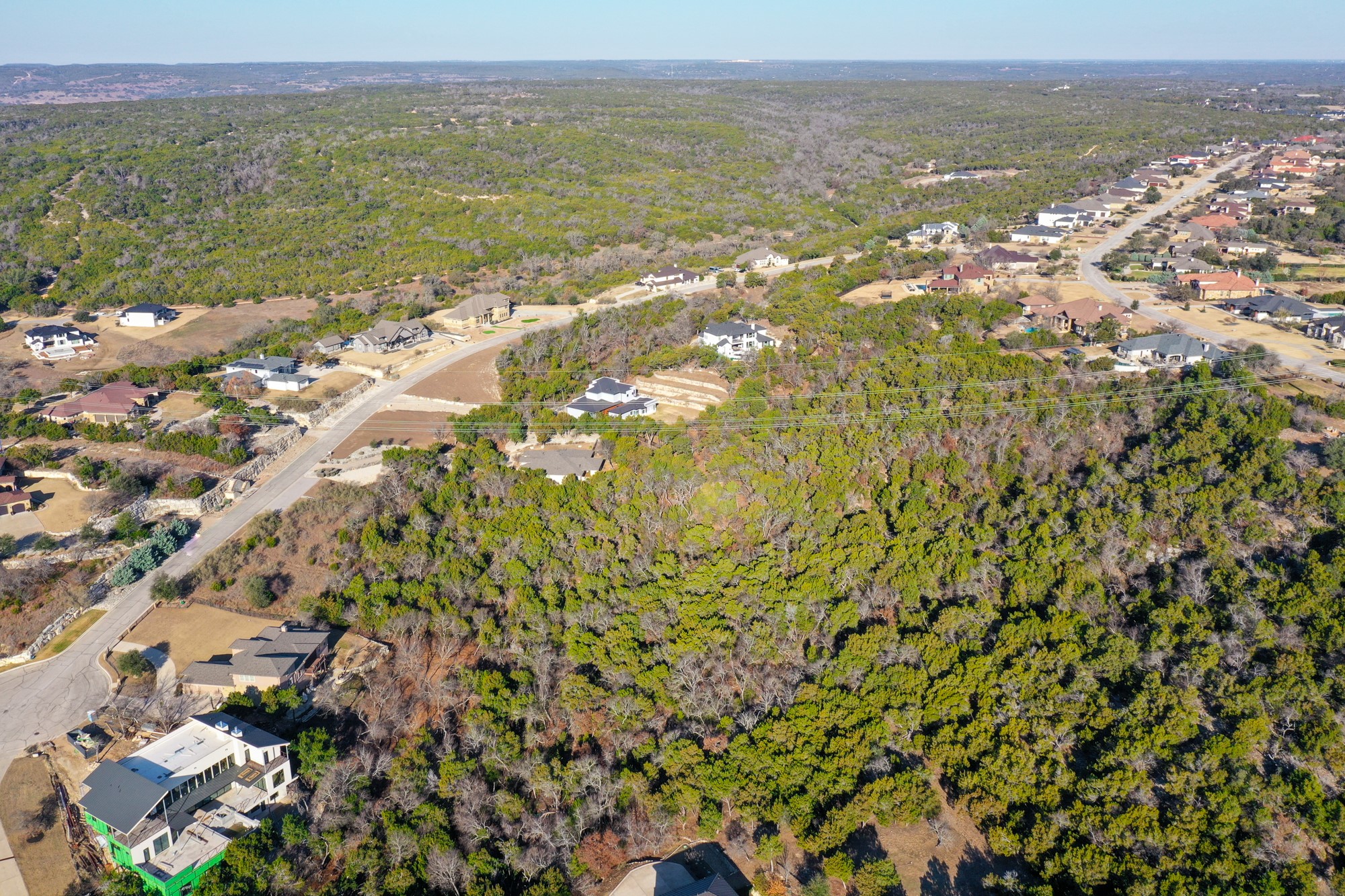 816 Laughing Dog Court Leander, TX 78641 - Photo 5 of 8 Aerial overview of property's location with a wooded area and nearby suburban area