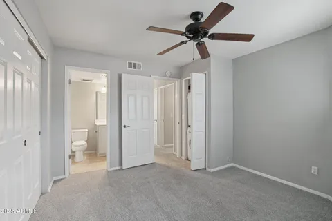 a bathroom with a granite countertop sink a toilet and a mirror