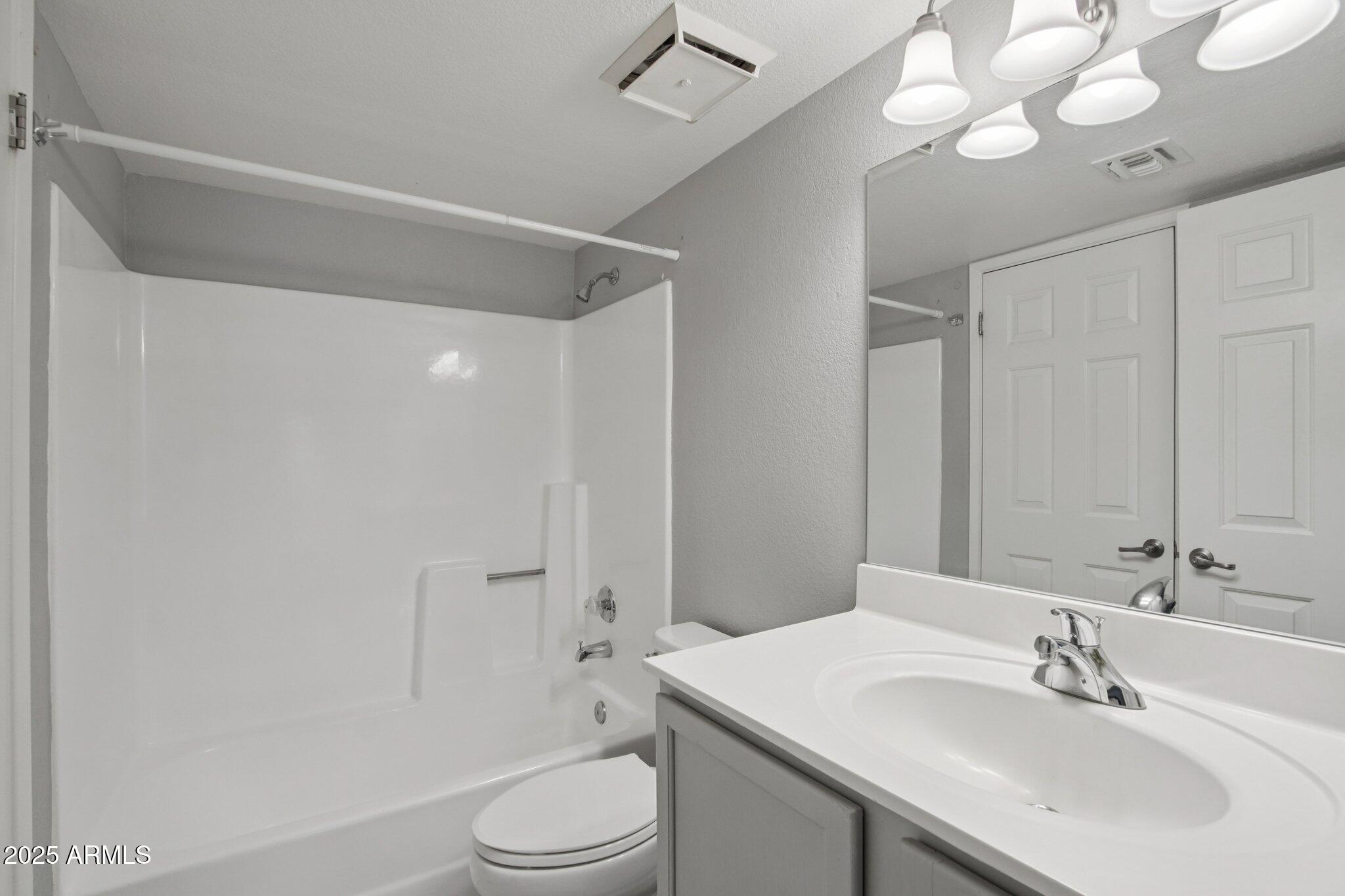 1720 East Thunderbird Road, Unit 2024 Phoenix, AZ 85022 - Photo 14 of 23 a bathroom with a sink a toilet a mirror and shower